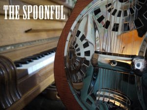 A resonator guitar with a piano in the background and The Spoonful logo top left