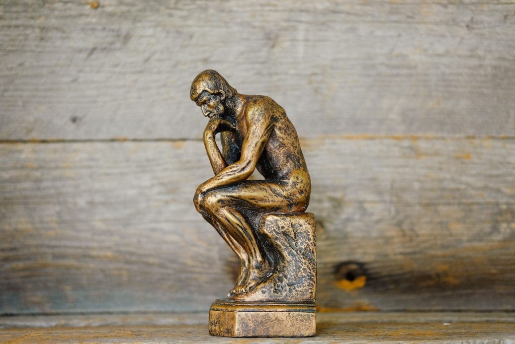 Bronze statue of a naked man in a thoughtful pose, symbolizing deep philosophical reflection—perfectly capturing the spirit of the philosophy debate group at The Grapes in Bath.