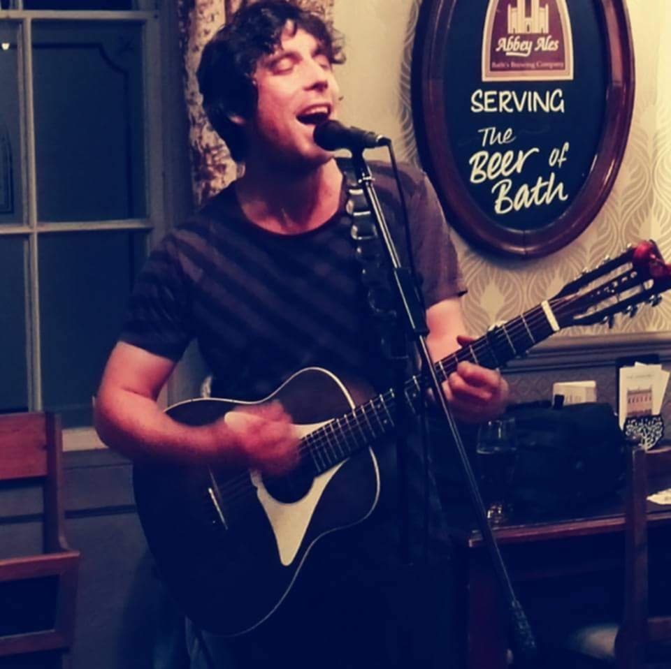 A picture of musician Kevin Brown performing in a bar
